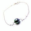 silver bracelet with a circled Tahitian pearl